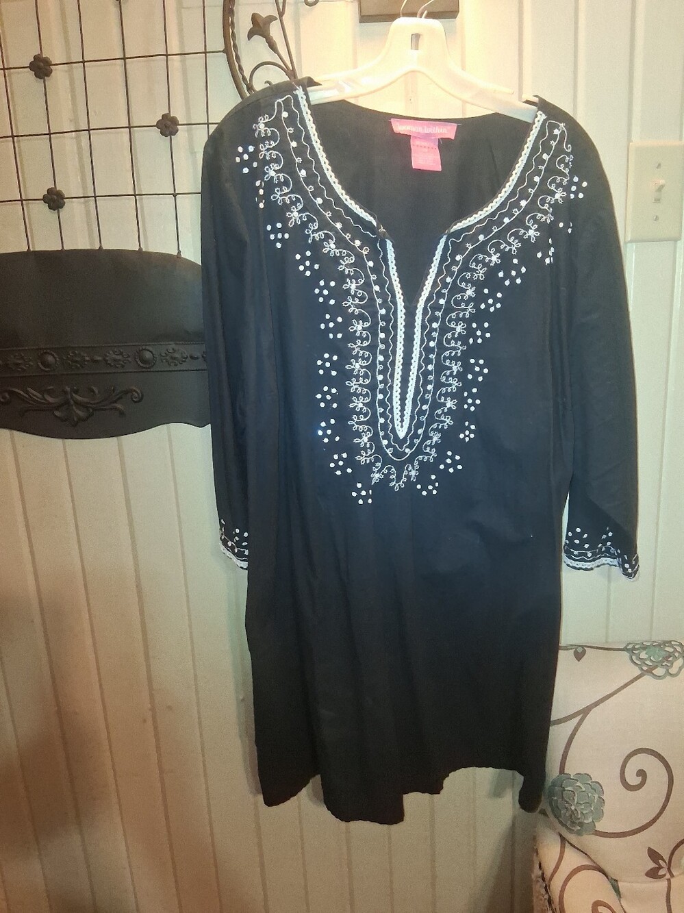 Woman Within Black Tunic with White Embroidery